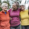 Multi generational women having fun together at park - Multiracial people meet and hugging each other outdoor